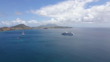 aerial view of a frigate and a cruise liner on the coast of saint kitts and nevis - pull back, drone shot