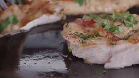 close-up of a juicy grilled chicken breast being cut with a knife