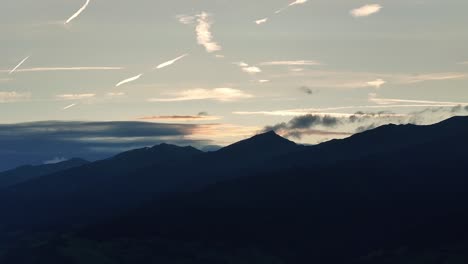 at the start of golden hour silhouettes of mountains and skies of different colours