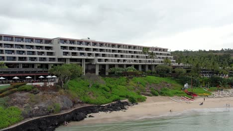 The-Mauna-Kea-Beach-Hotel,-golf-course-and-surroundings-on-a-beautiful-day-on-the-Big-Island-of-Hawaii---aerial-flyover