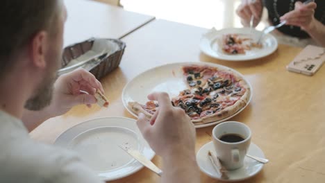 people eating pizza at a restaurant