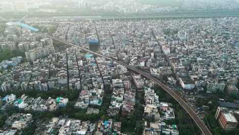 metro train going from noida sector 15 to new ashok nagar station drone following train in noida top view delhi in india