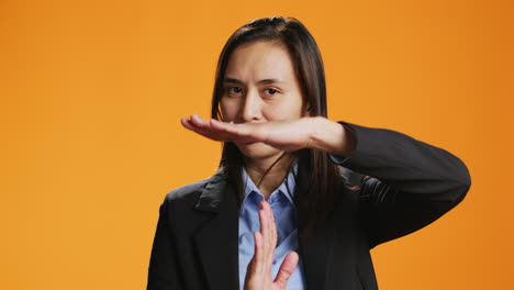 serious adult presenting timeout gesture in studio