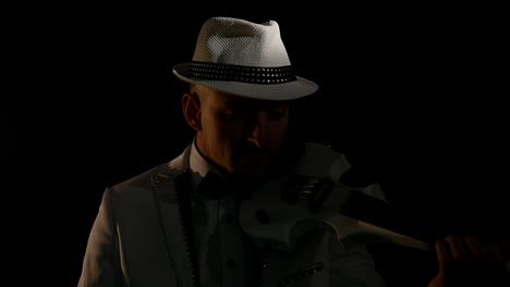 musician playing a violin on black background