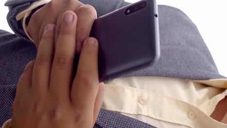 Business-man-texting-on-smartphone-with-both-hands,-close-up