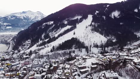 ski slope trail in austrian town of zell am see, aerial drone view, 4k, day