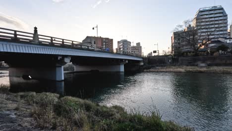 time-lapse of a river in a city from day to dusk.