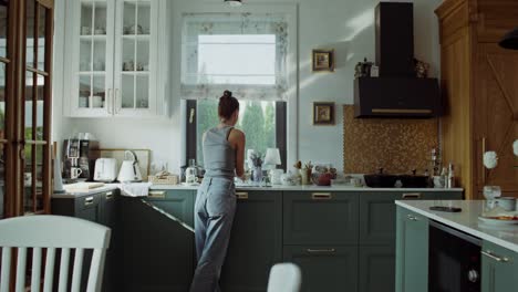 woman drinking water in a modern kitchen