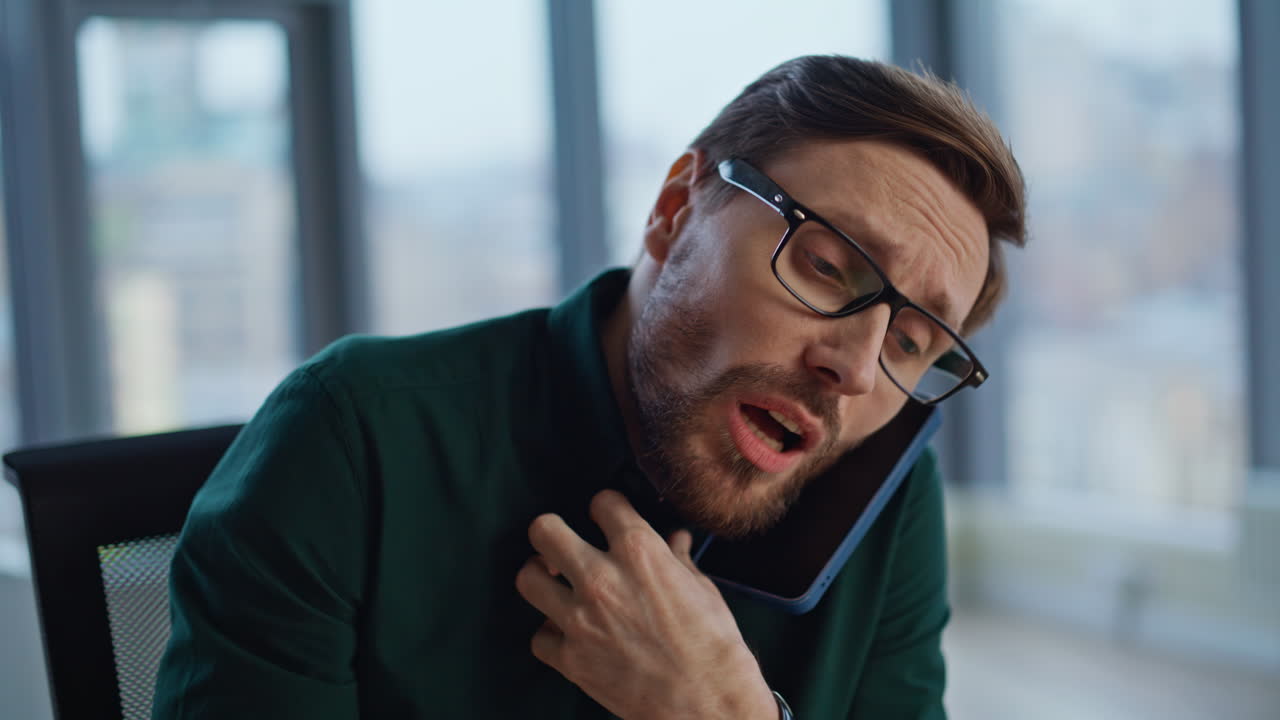 Professional displeased cellphone call explaining issues in workplace closeup