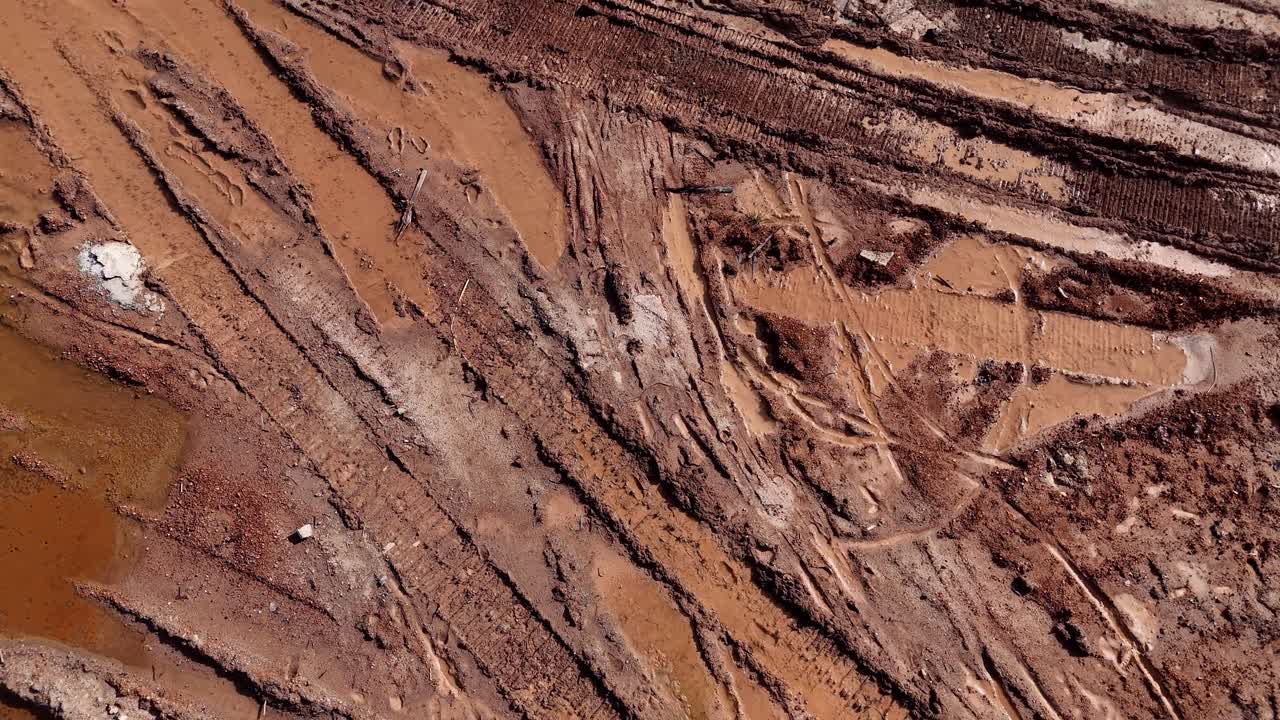 Muddy Tire Tracks on a Dirt Road
