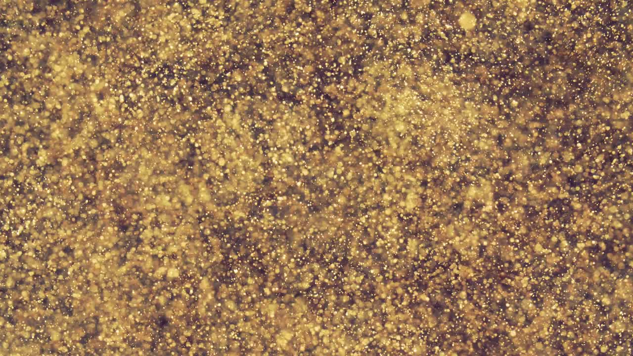 partículas doradas abstractas con borroso desfocado bokeh se mueve caos, copos de nieve