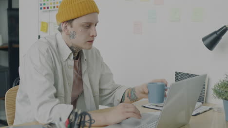 young man working on laptop in a home office