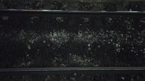 black stones with metallic silver railway close up shot of station infrastructure