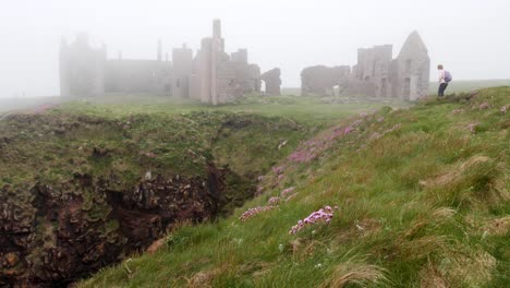 Lady-walker-approaches-Slains-Castle-from-the-north-past-a-steep-gully