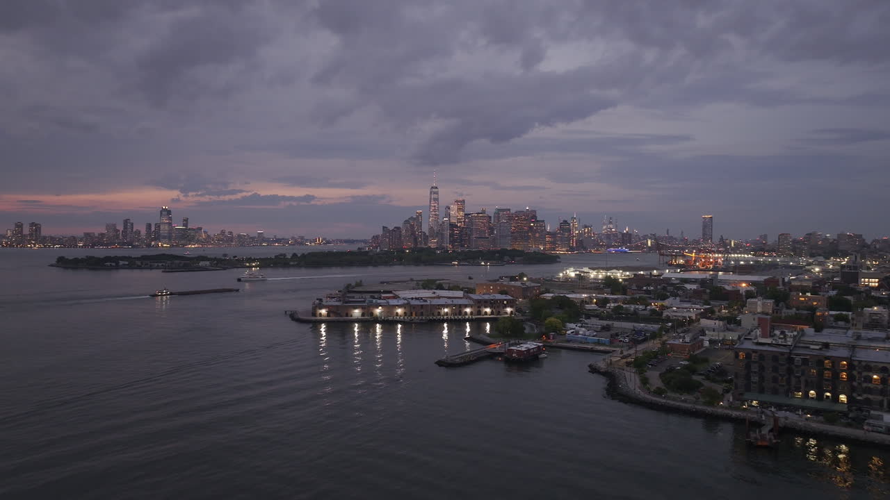 Aerial view of Brooklyn and the Manhattan skyline at night. Shot in Red Hook along the New York Harbor and Governor's Island.