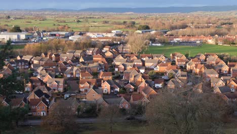 a housing estate with a red brick group of houses development in the west country town of glastonbury in somerset, england