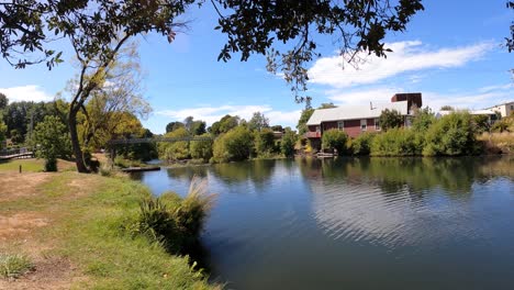 people along banks of meander river in deloraine city, tasmania in australia