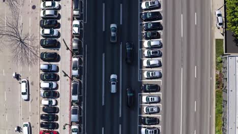 aerial overhead roadway revealing dense la highway traffic, multiple lanes filled with vehicles, parking areas framing metropolitan transportation landscape
