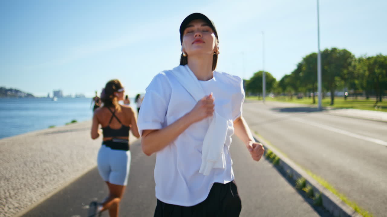 Energetic woman running road at sunny morning closeup. Sporty lady jogging