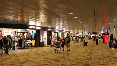 passengers walking through a bustling airport terminal