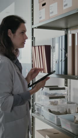 scientist reviewing archival records in storage room