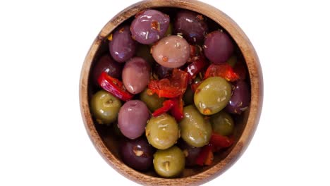 Animation-of-olives-in-bowl-over-white-background