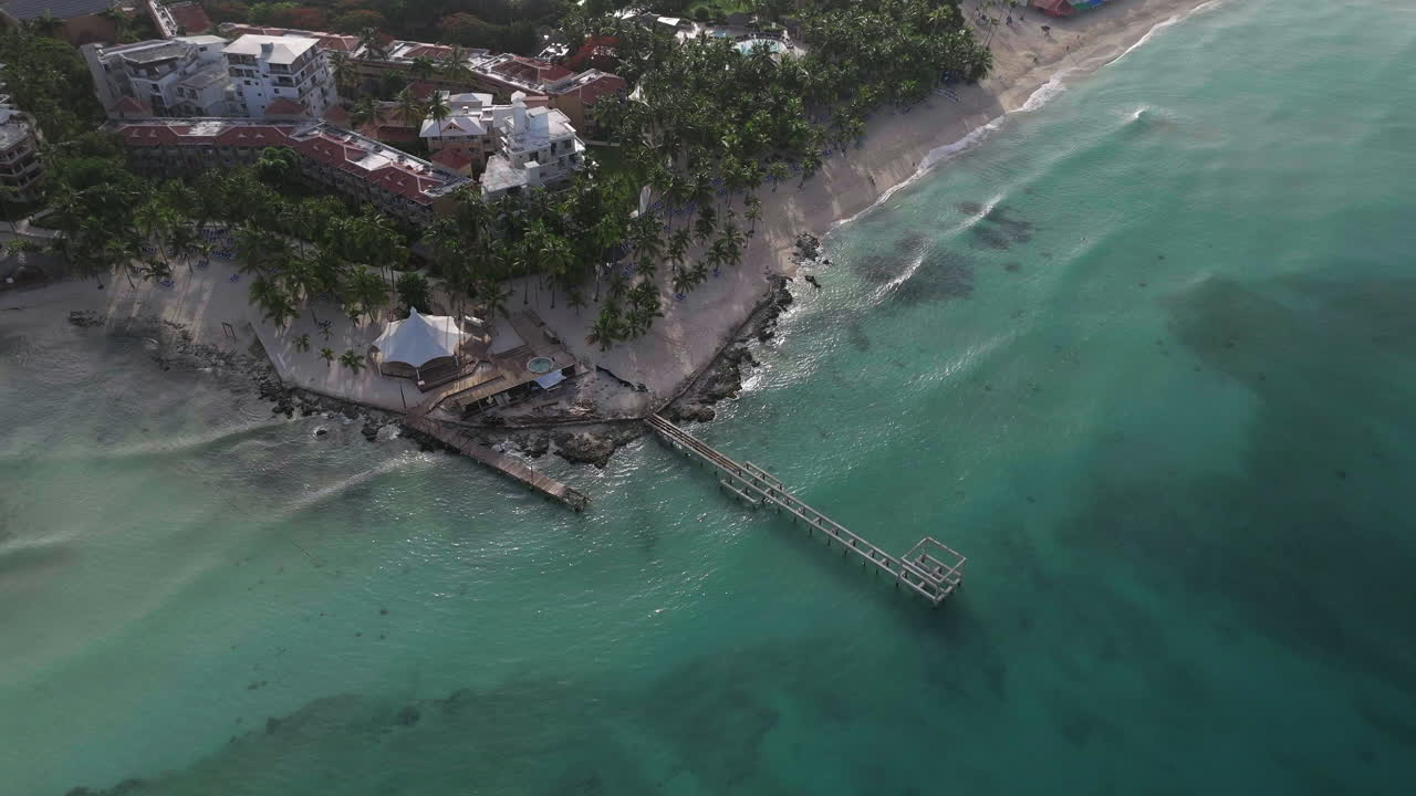 Aerial view of a tropical beach resort with a pier