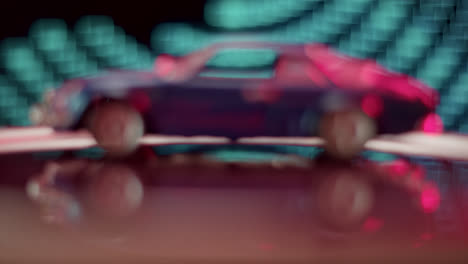 blue toy sports car with vibrant neon reflections