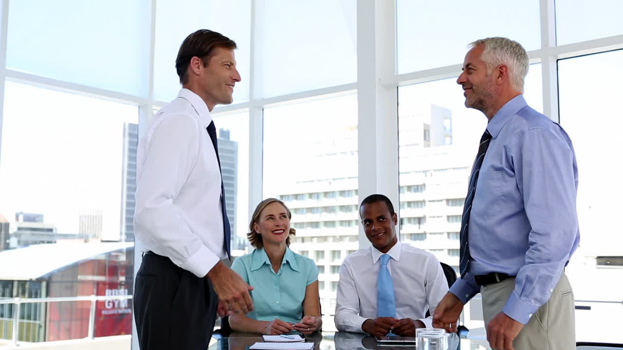 Businessmen shaking hands in the meeting room