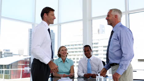 businessmen shaking hands in the meeting room