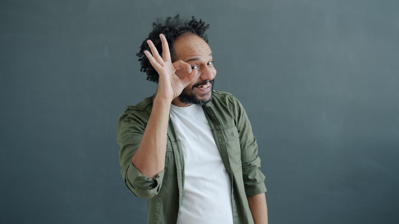 Smiling Man in Khaki Shirt