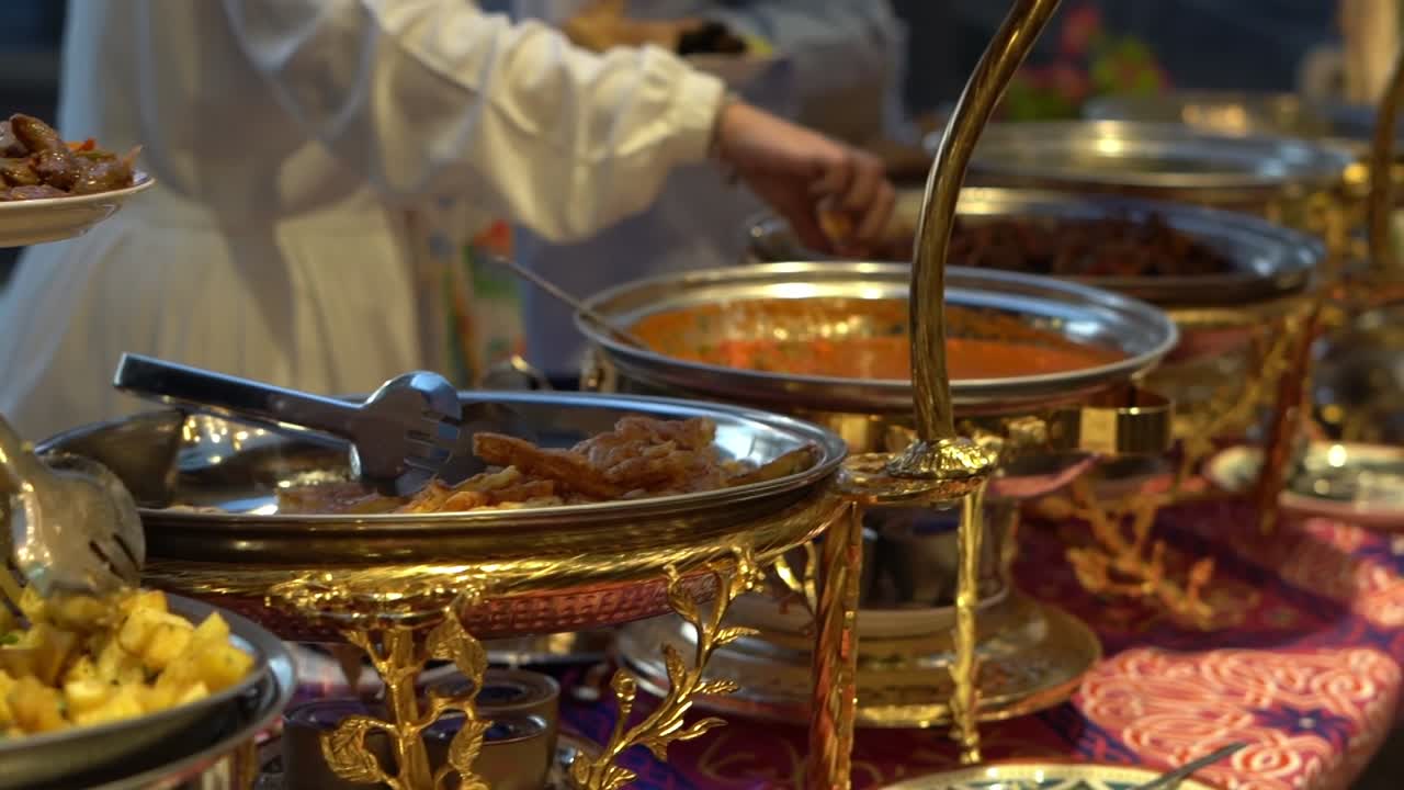 people pick their food in open buffet, close up shot, high angle shot
