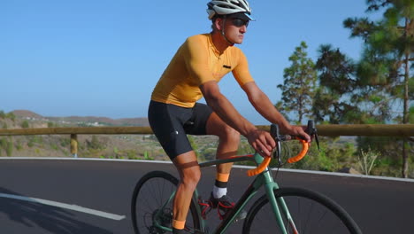 amid the serenity of the morning, a man takes his road bike for a ride on an empty road, indulging in outdoor exercise. the slow-motion capture accentuates the essence of extreme sports