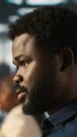 vertical video employee looking over revenue figures on documents in office