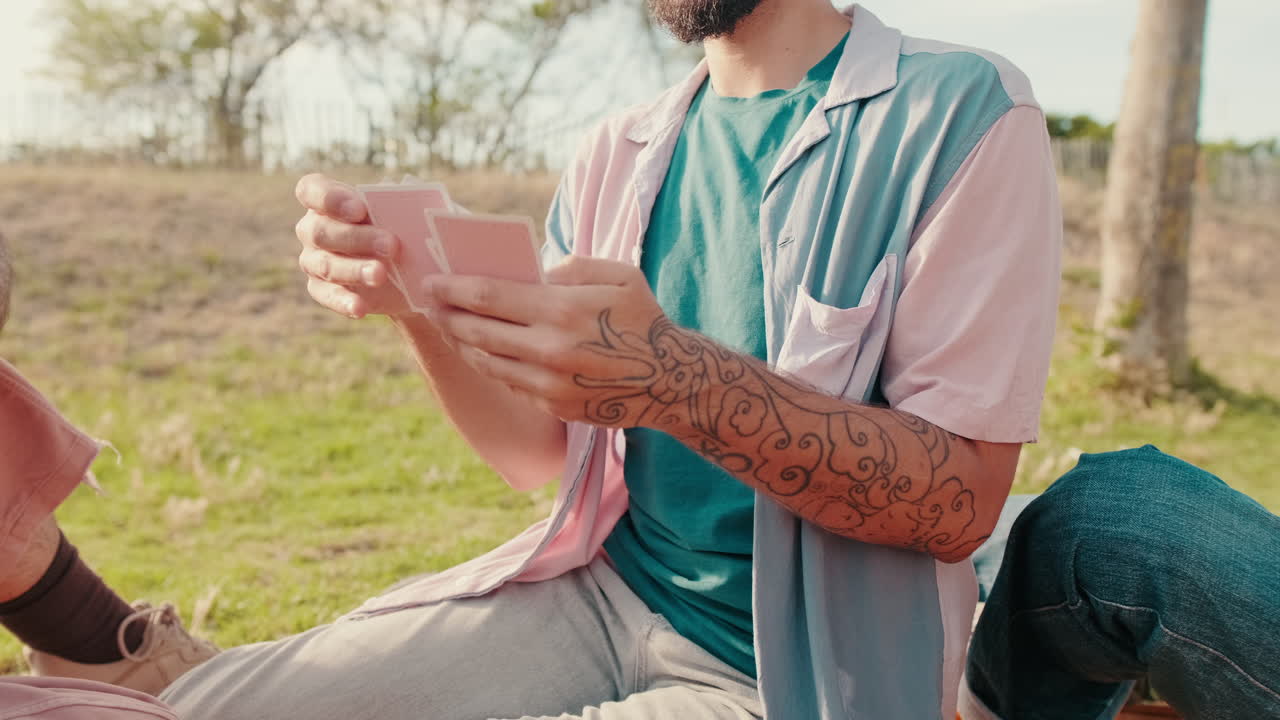 Friends Playing Cards at a Sunny Picnic