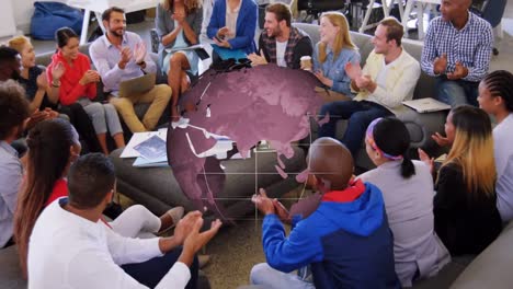 Animation-of-globe-rotating-over-diverse-creative-colleagues-clapping-at-casual-office-meeting