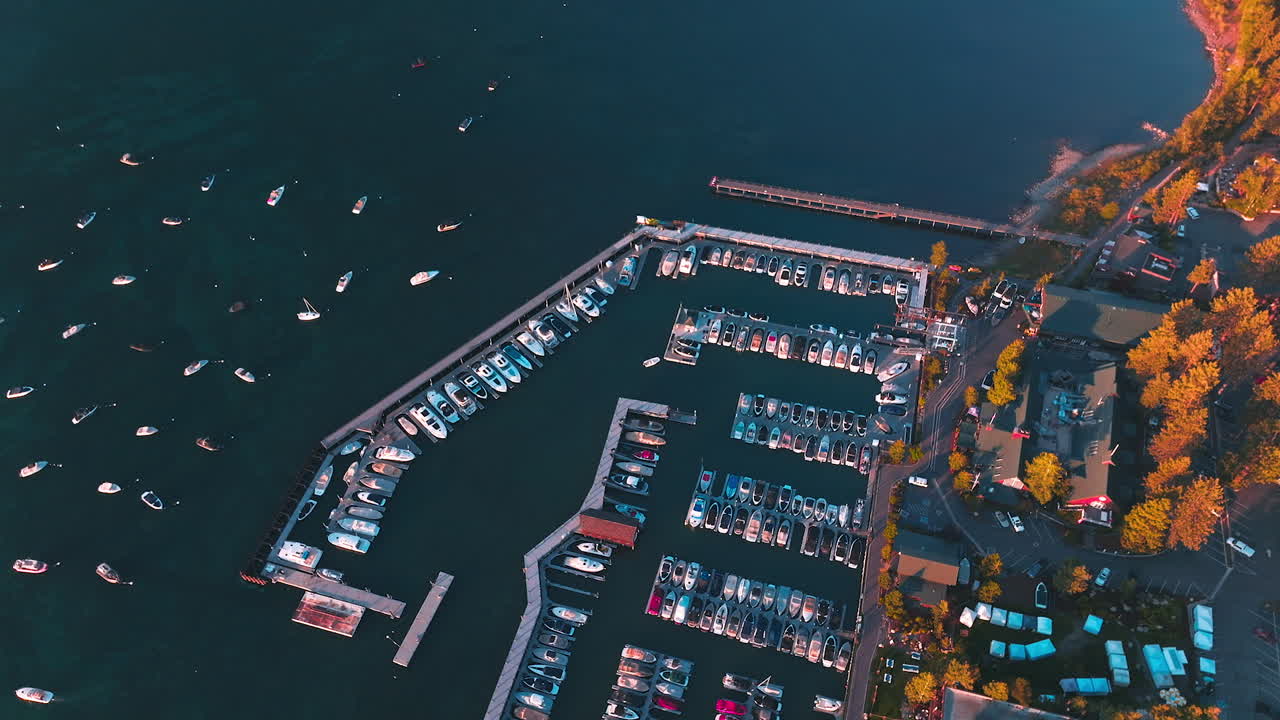 Boat pier with multiple yachts. Many boats are on the lake. Beautiful bank of Lake Tahoe, California, USA. Aerial view.