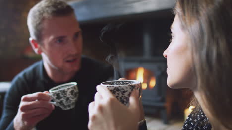 Close-Up-Of-Couple-Sitting-At-Table-Drinking-Tea-In-Traditional-English-Holiday-Hotel