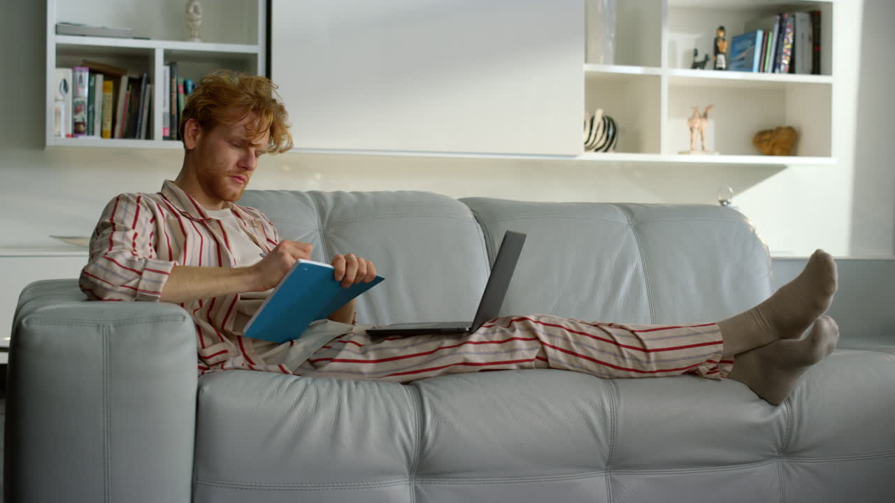 Manager working making notes in pajamas at remote office. Student watch seminar