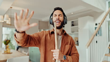 man listening to music and dancing at home