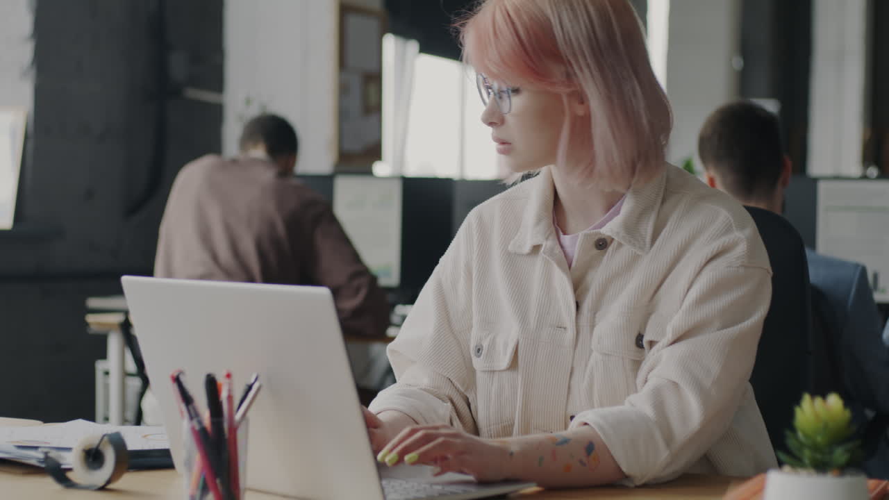 Young woman working on laptop in a modern office