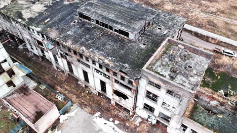large buildings of an old abandoned factory not used for a very long time. forlorn empty premises with no windows or parts of the walls. aerial view.