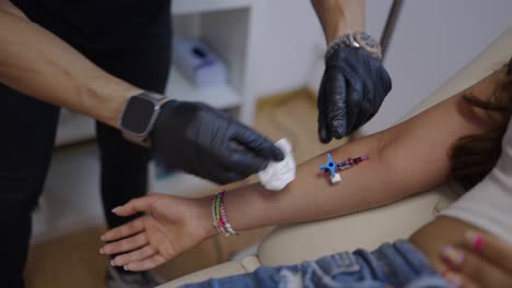 medical professional preparing an arm for iv cannula insertion