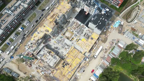 aerial view of construction site with crane and building