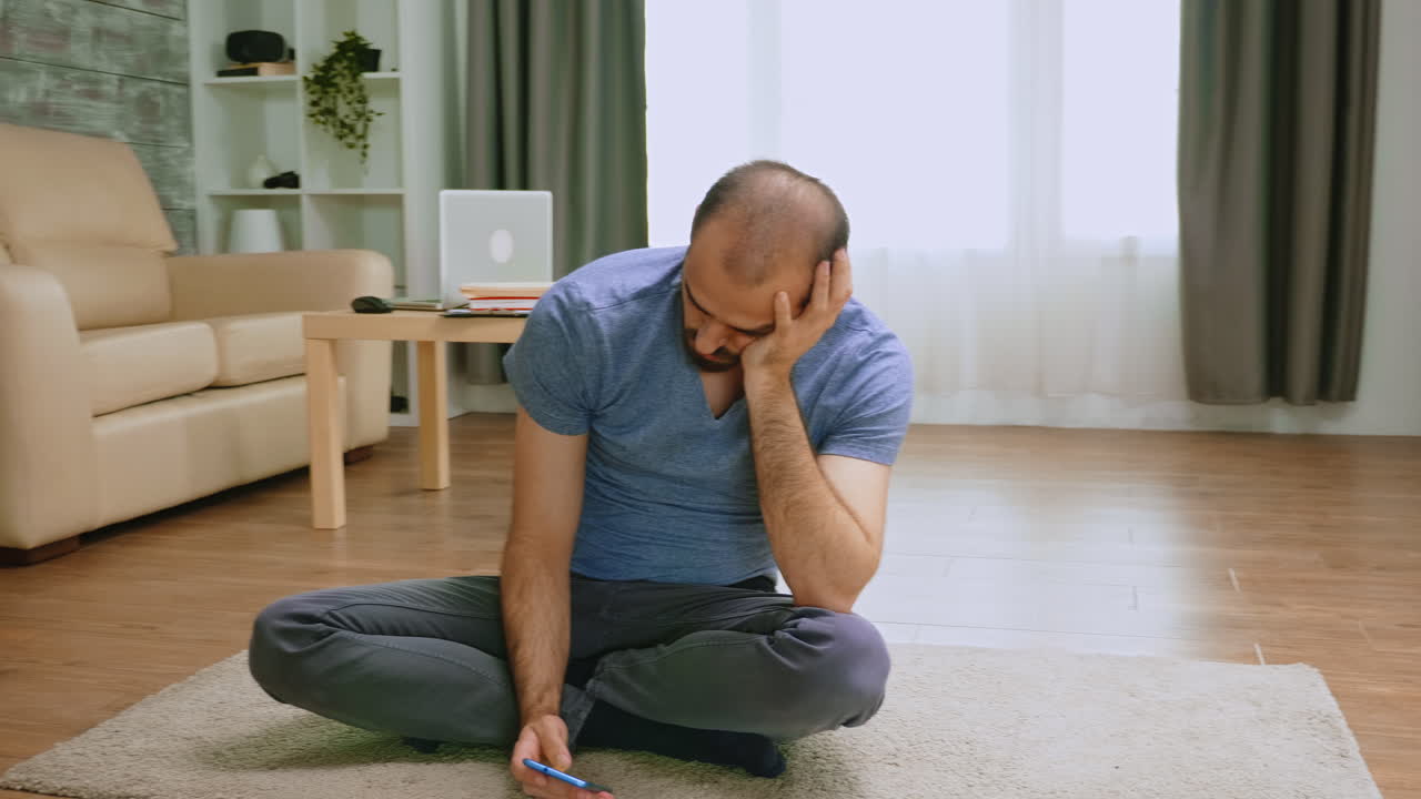 Pensive man using his phone