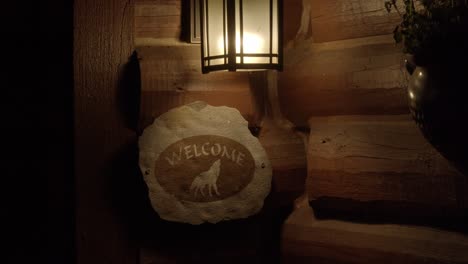 welcome sign lit during the evening with a wolf design