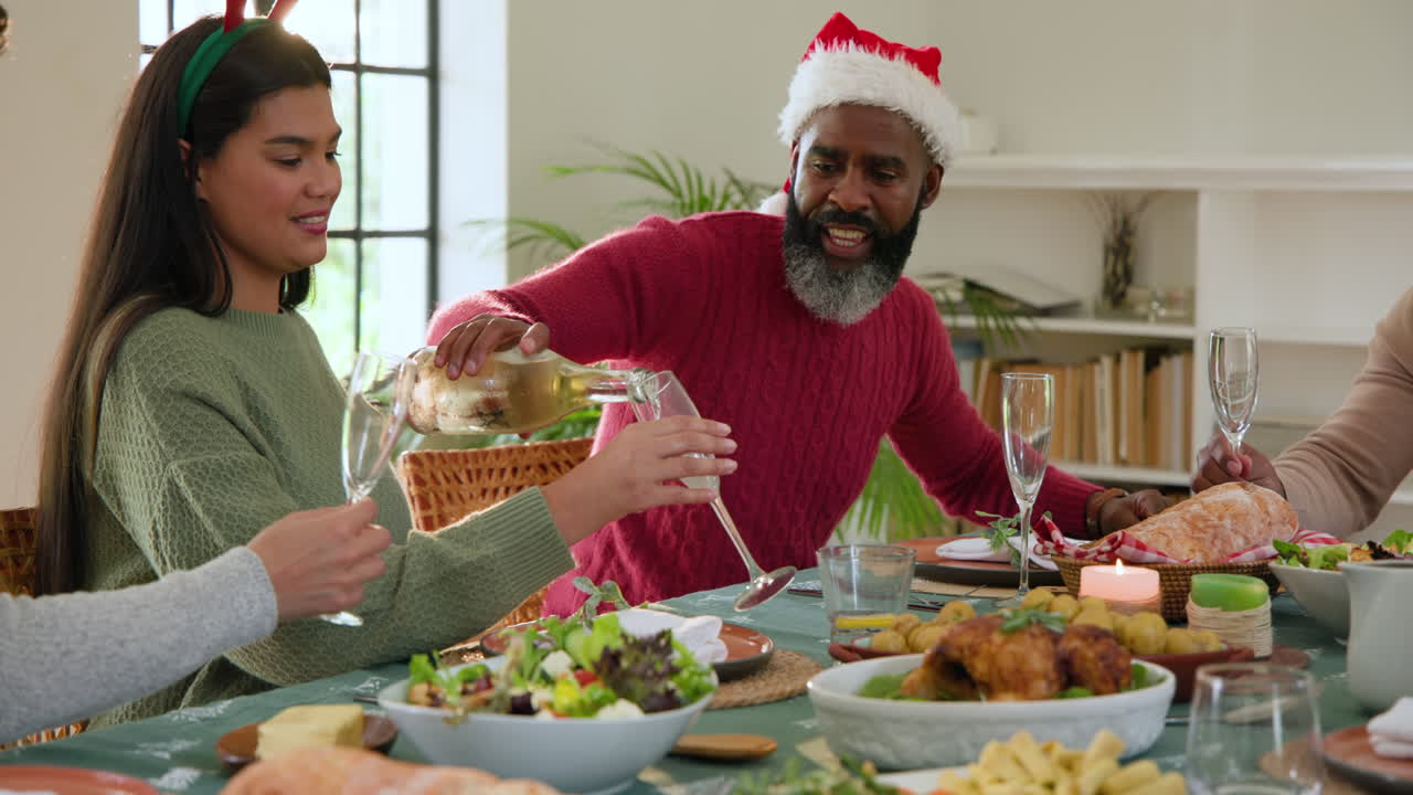Celebrating Christmas, Diverse family sharing joyful moments and pouring wine at dinner table