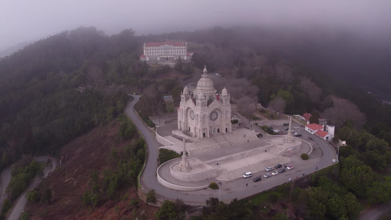 Wide shot of Santu&aacute;rio de Santa Luzia Portugal during a moody day low clouds, aerial