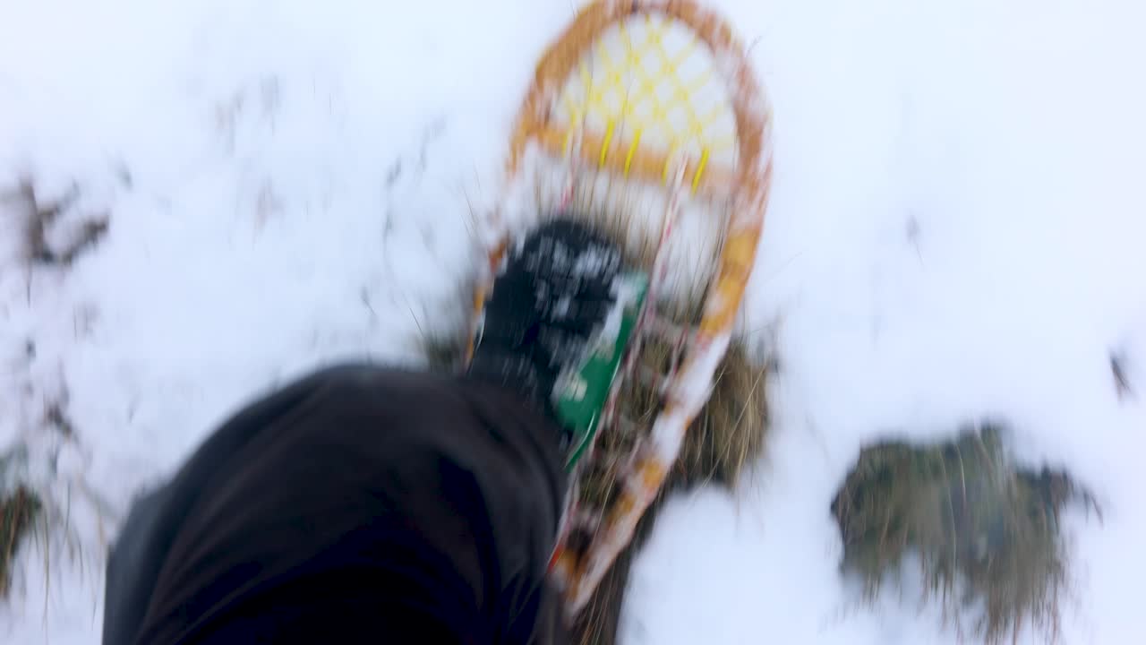 두꺼운 눈 속을 트레킹하는 전통적인 낡은 눈 신발의 관점