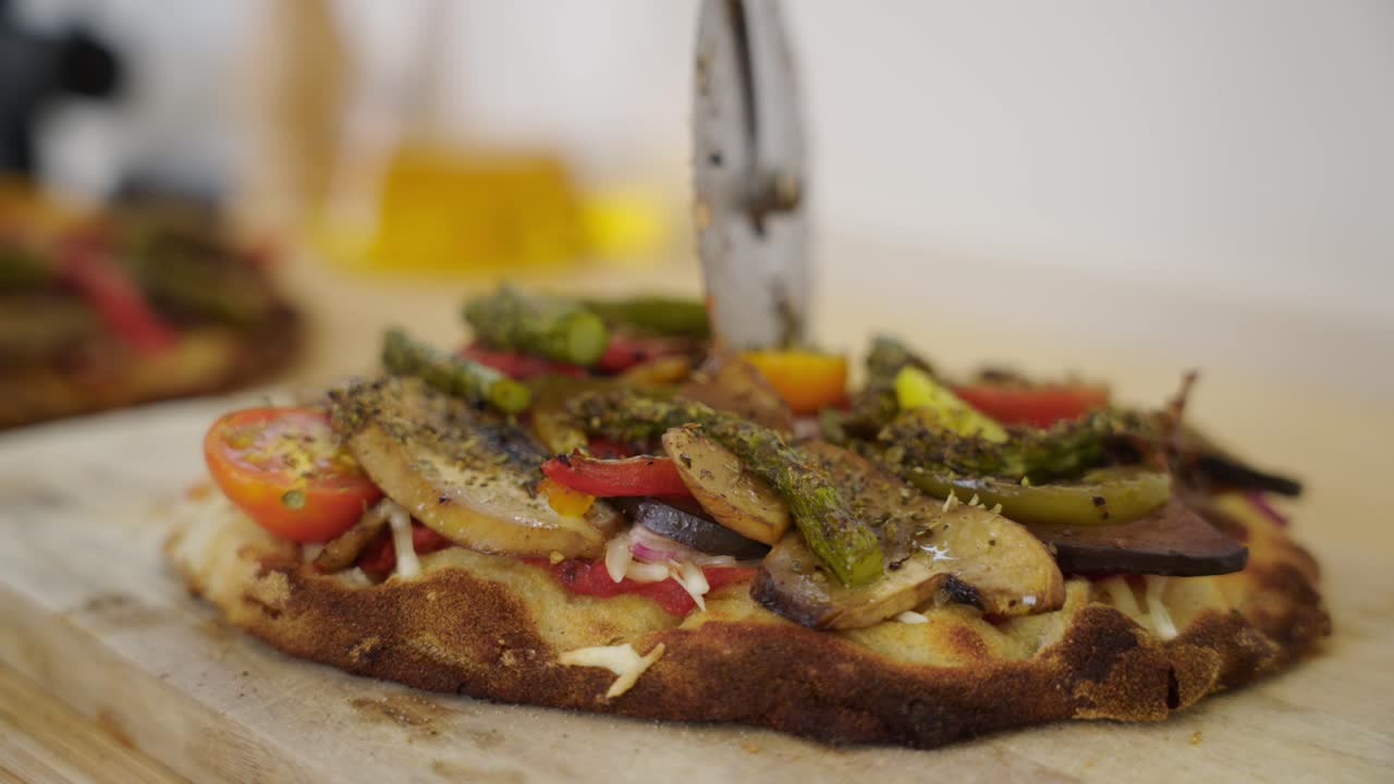Cutter Roll Over Pizza Loaded With Various Vegetable Toppings Like Mushroom And Asparagus. Close-up Shot